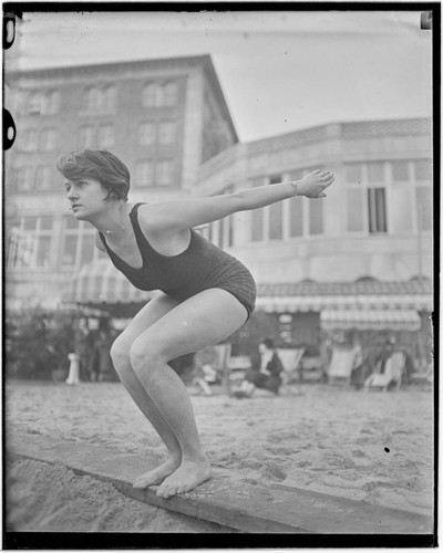 Swimmer in dive pose in front of Club Casa del Mar, Santa Monica, California