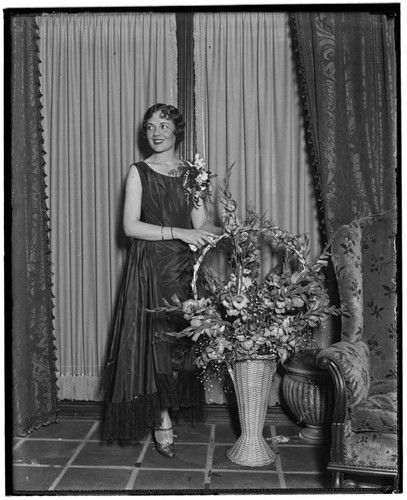 Woman with a corsage and flowers at the Club Casa del Mar, Santa Monica, California