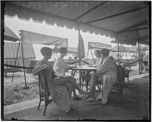 Swim team at a table at the Club Casa del Mar, Santa Monica, California