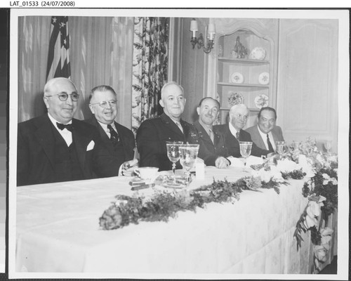 Harry Chandler at dining table with others