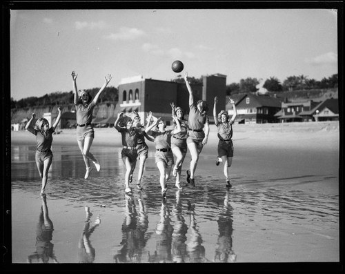 Women tossing a basketball around on the beach, Santa Monica
