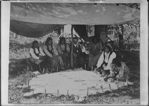 Kiowa Indians painting history on a buffalo hide, Indian Territory