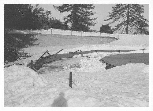 Collapsed fence around water reservoir after snowfall, Mount Wilson Observatory