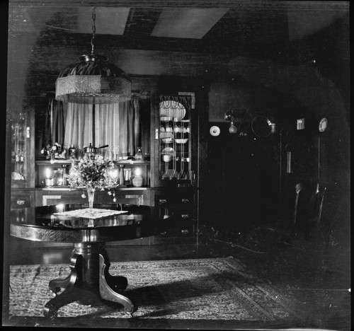 Unidentified house interior with flowers on table