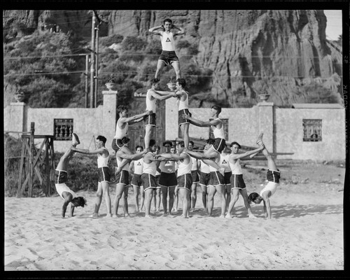 Gymnasts pose in human pyramid, Gables Beach Club, Santa Monica