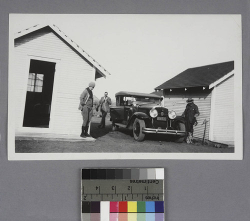 Grace Burke Hubble, Edwin Powell Hubble and Garry Baldwin standing around a car in Cameron, Arizona