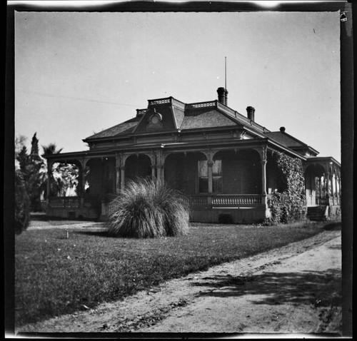 Unidentified brick house with wrap-around porch