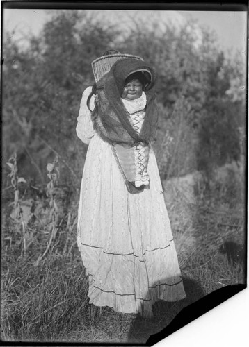 Nevada Paiute Indian mother carrying baby in its cradle