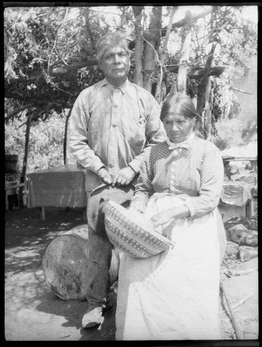 Joe and Mary Jololla with basket. Yokuts. Tule River Reservation