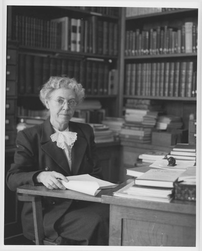 Elizabeth Connor seated at her desk, Mount Wilson Observatory Library, Pasadena