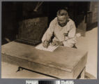 Chinese merchant with abacus in Old Chinatown, Los Angeles