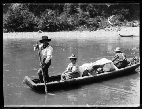 Grace Nicholson sitting in canoe, with Frank Ruben (Karok) paddling, on the Klamath River