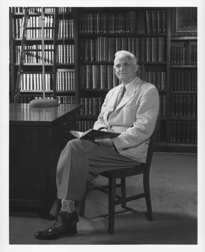 Roscoe F. Sanford, seated in the Hale Observatories Library, Pasadena