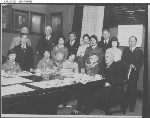 Harry Chandler poses with group of Japanese men and women and others
