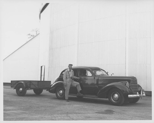 Tom Nelson standing beside a car in front of the 100-inch telescope dome, Mount Wilson Observatory