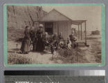 Visitors in front of cottage on the beach, Santa Monica