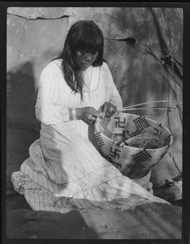 Southwest Indian woman weaving basket