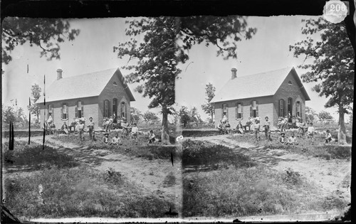 Small schoolhouse with students and teachers standing outside, Sac & Fox Agency, Indian Territory