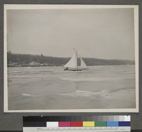 Skate sailing on frozen Lake Geneva, with Yerkes Observatory to the left in the background