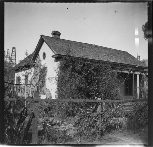 House with oil wells in the background, Los Angeles