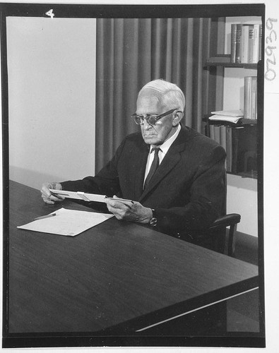 Alfred H. Joy, seated at his desk