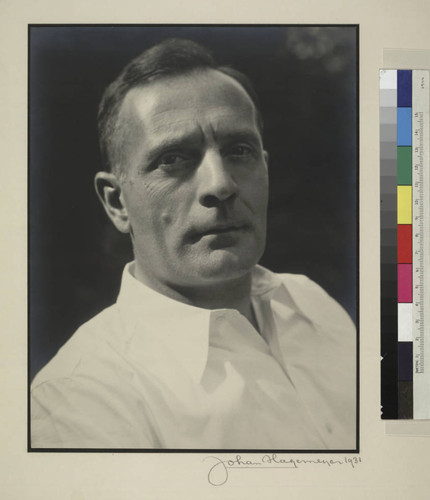 Studio portrait of Edwin Powell Hubble in a white shirt