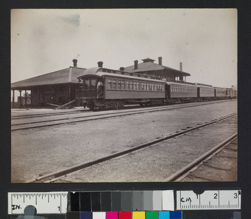 A train depot, with train cars stopped along the tracks