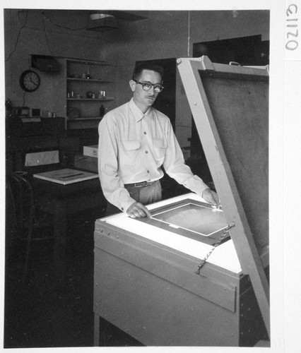 James McClanahan at the contact printer for sky survey atlas prints, Palomar Observatory