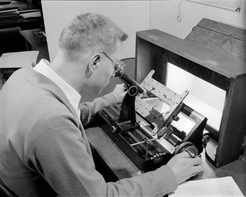 Jack Rogerson, seated at a measuring machine