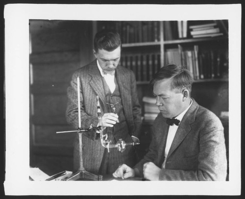 Edison Pettit and Mr. Dietz in Pettit's office with a thermocouple