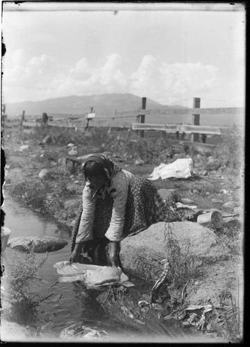 Washoe woman washing clothes in the river near Sparks, Nevada, 1912