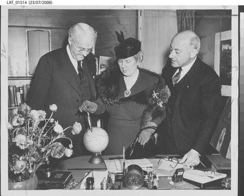 Harry Chandler, Mrs. Mattison Boyd Jones and Cecil B. DeMille with a small globe