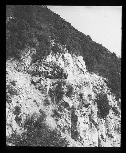 Tube of the 60-inch telescope being transported up a road on Mount Wilson