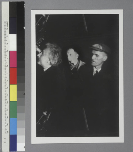 Albert Einstein, Edwin Powell Hubble and Walter Sydney Adams standing by a telescope