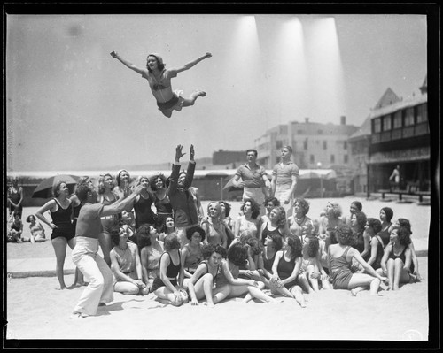 Woman tossed in the air on the beach, Santa Monica