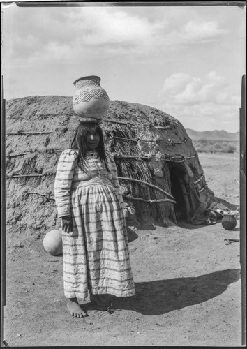 Woman with pot on head. Copyright 1901