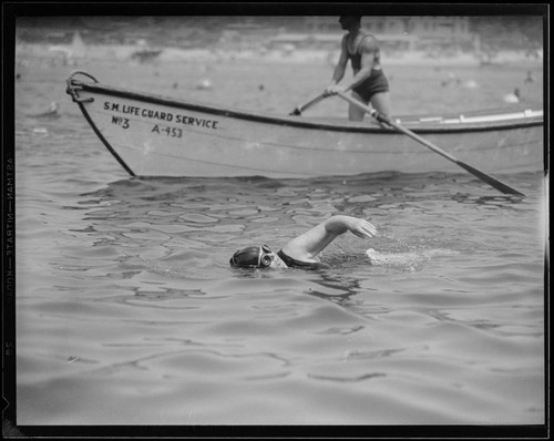 Swim meet winner swimming at the Yacht Harbor breakwater dedication, Santa Monica