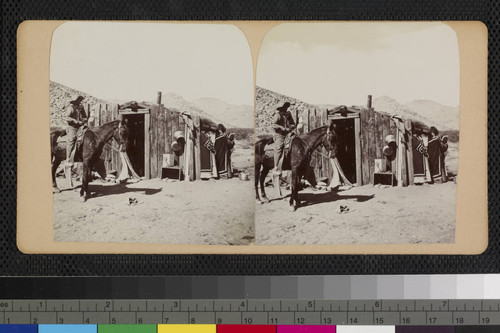 Hualapai Indian on horse and two Hualapai women next to house