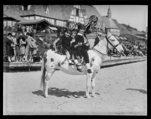 Meglin Kiddies riding a mule in front of Gables Beach Club, Santa Monica