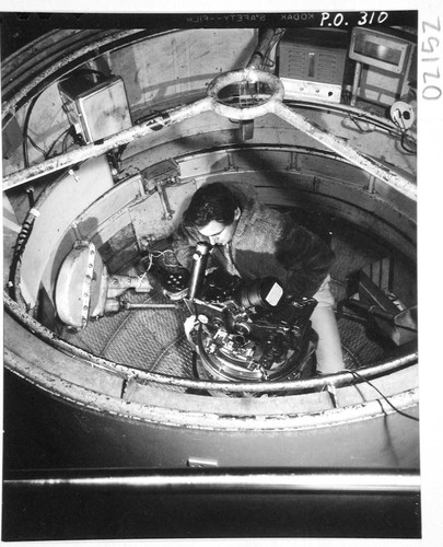 Halton C. Apr at the 200-inch telescope prime-focus spectrograph in a cage, Palomar Observatory