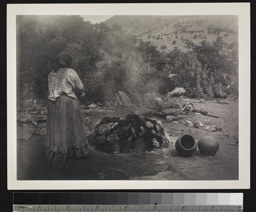 Papago Indian woman using oven for pottery. Near Bisbee, Arizona