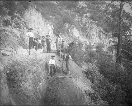 Asian construction workers widening a toll road below the Pasadena Gap, San Gabriel Mountains