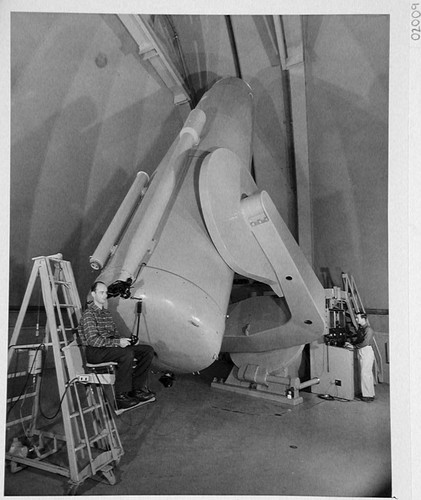 The 48-inch Schmidt camera, Palomar Observatory, with Bill Baum seated at the guidescope and Chuck Kearns standing at the control desk