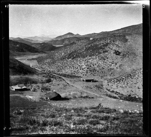 Landscape view of valley and ranch buildings