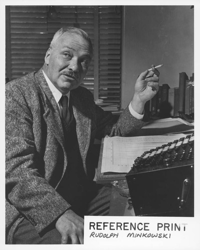 Rudolph Minkowski seated at his desk