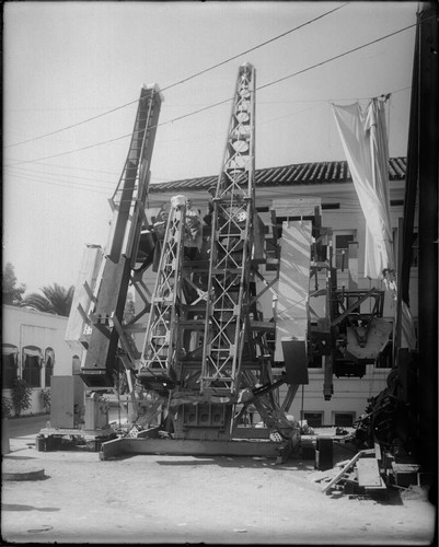 Attaching cameras to the 50-foot interferometer mount in front of Mount Wilson Observatory's machine shop, Pasadena