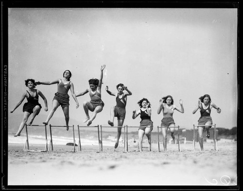 Roger Cornell's Athletic Club women jumping hurdles on the beach, Santa Monica