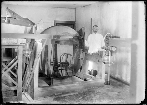 Optician with 60-inch mirror blank at the Mount Wilson Observatory Optical laboratory, Pasadena