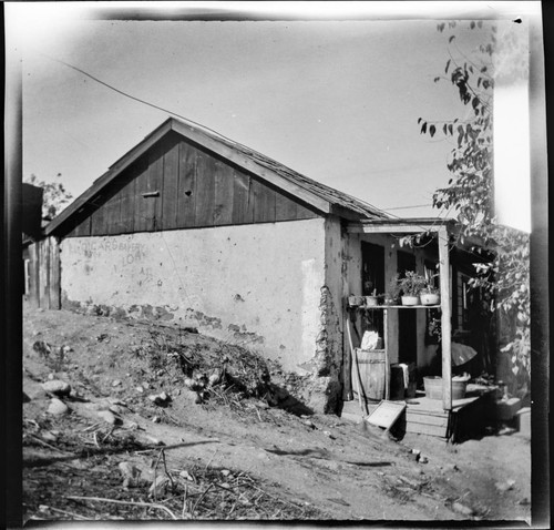 Adobe house with writing on wall