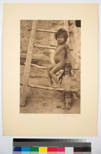 Hopi boy sitting on ladder